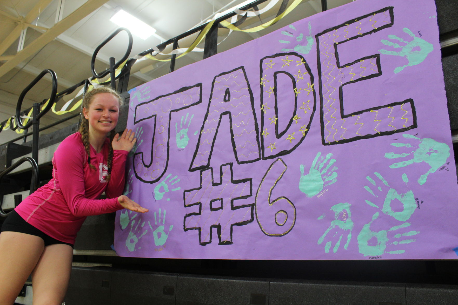 Jade Monday stands in front of her sign